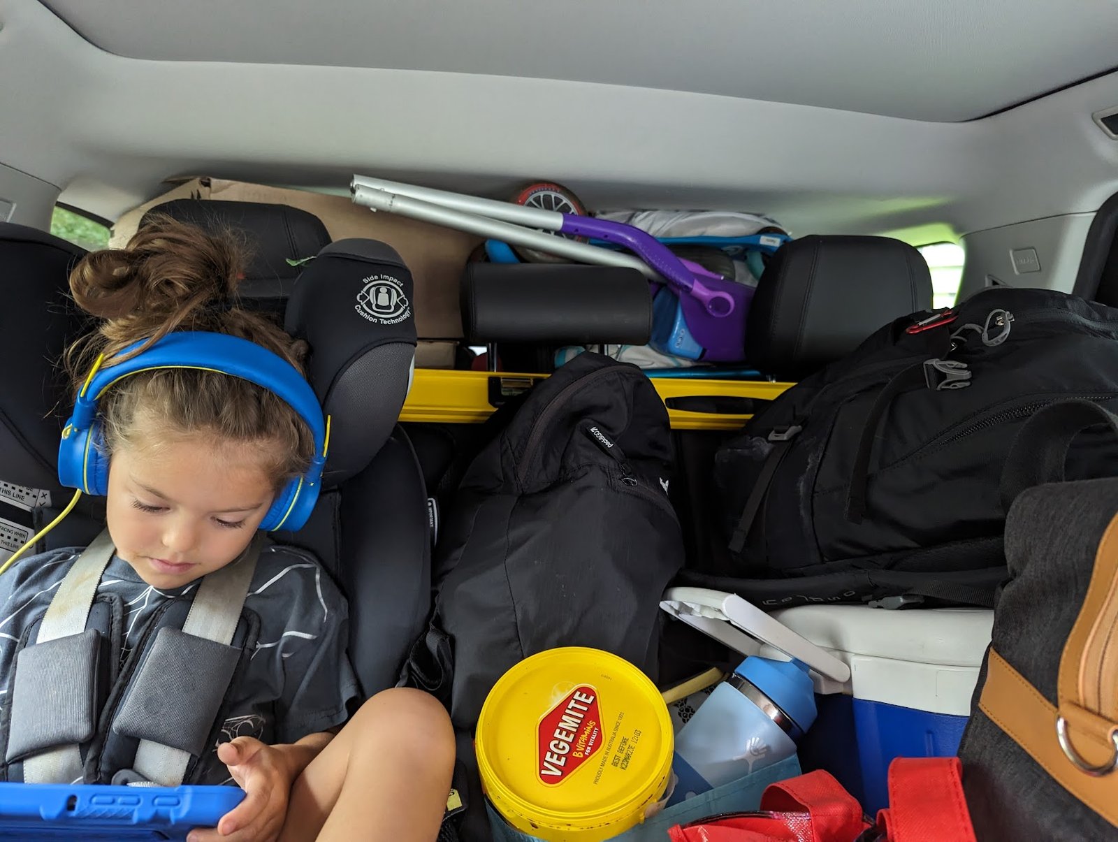 toddler in a crowded backseat - 