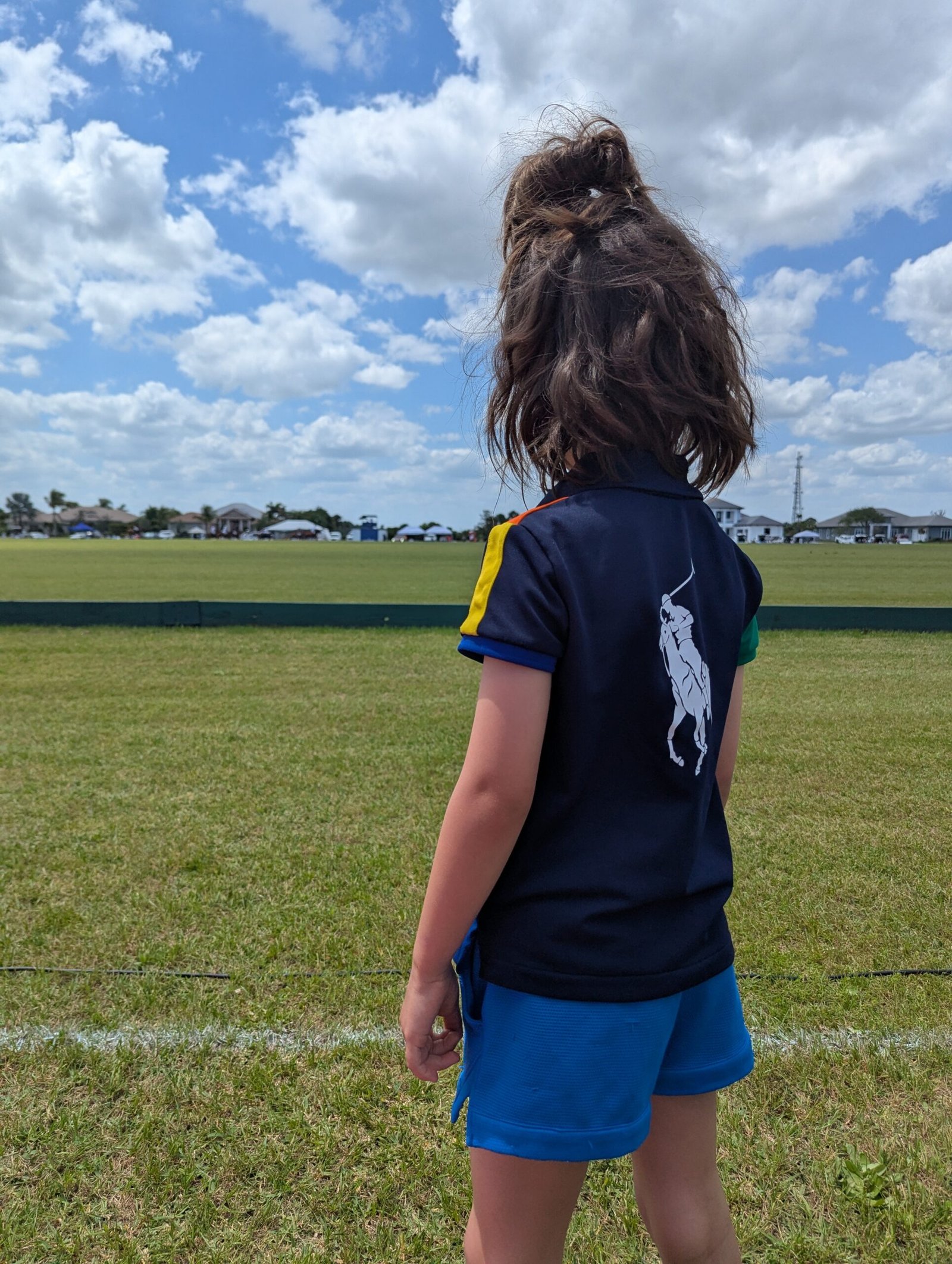 Remi watching polo at vero beach polo club - things to do in vero beach with kids