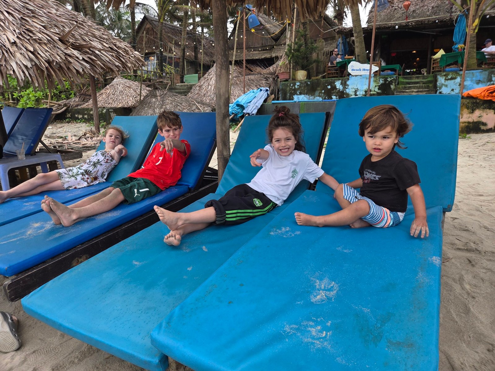 Kids on lounge chairs on An Bang beach