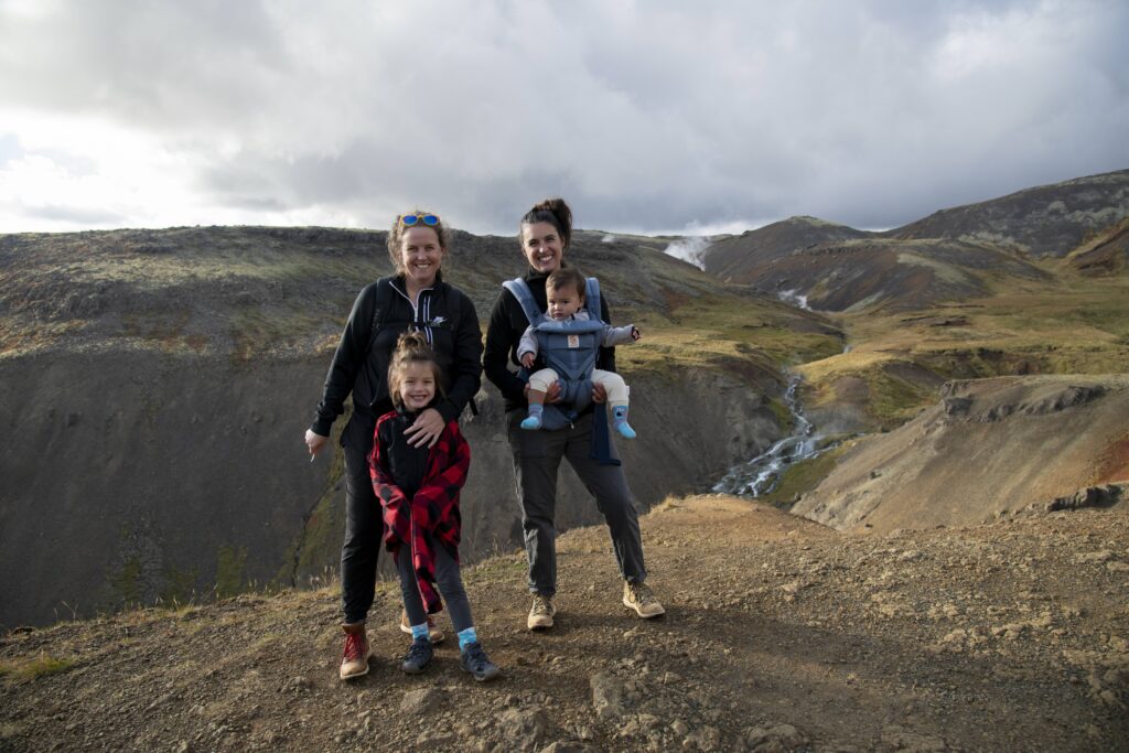 Alissa Dani Remi Arlo hiking in Iceland posting on a hiking trail cliff