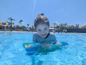 Remi at the pool - how to save money for travel as a family
