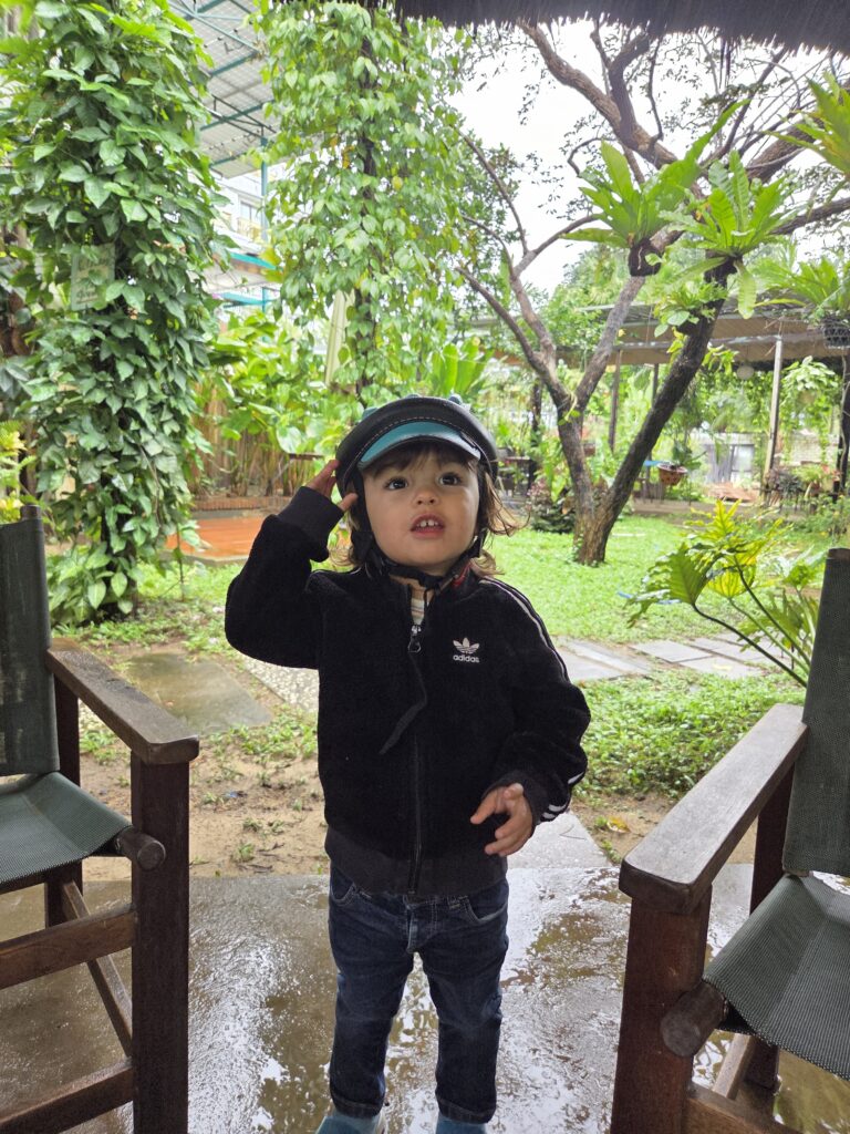 Toddler with scooter helmet in Hoi An