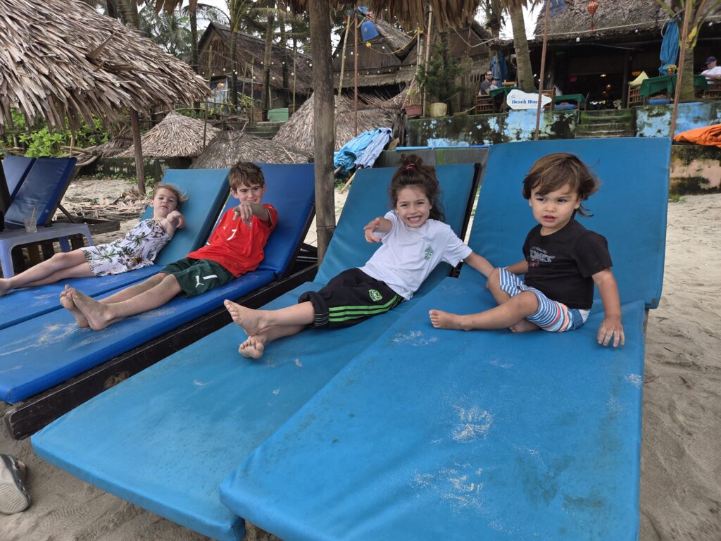 Kids on lounge chairs on An Bang beach