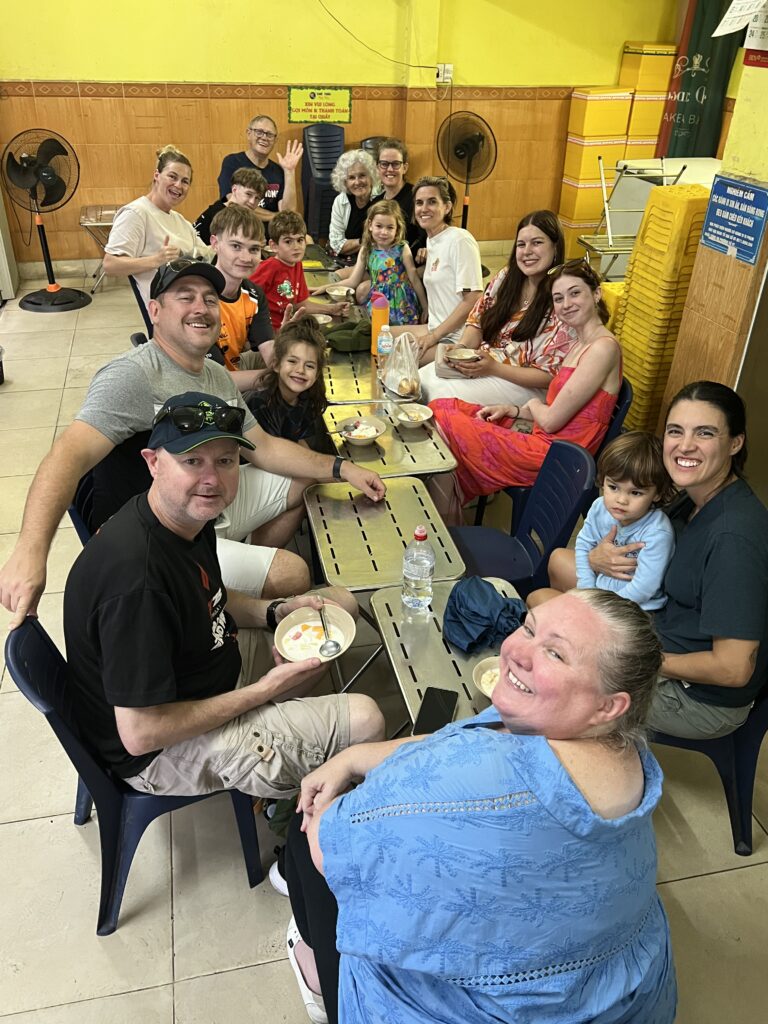 Family at small table in a dessert shop in Da Nang