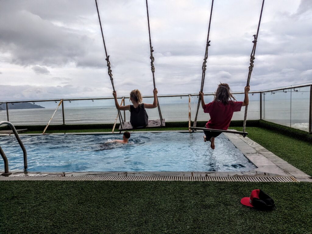 Kids on swings over a pool at a rooftop villa in Da Nang Vietnam