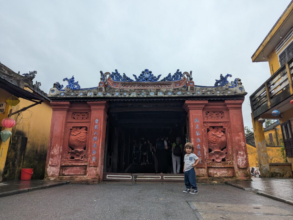 Arlo in front of the ancient japanese covered bridge in Hoi An
